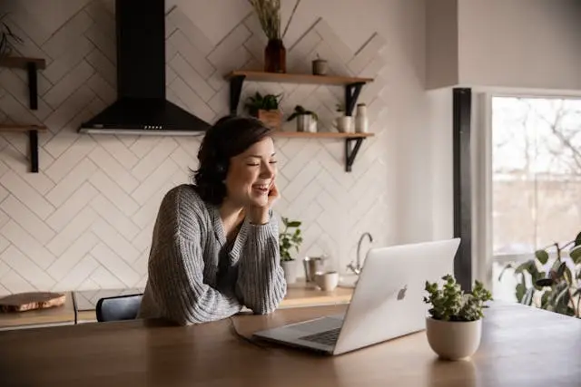 woman smiling at laptop